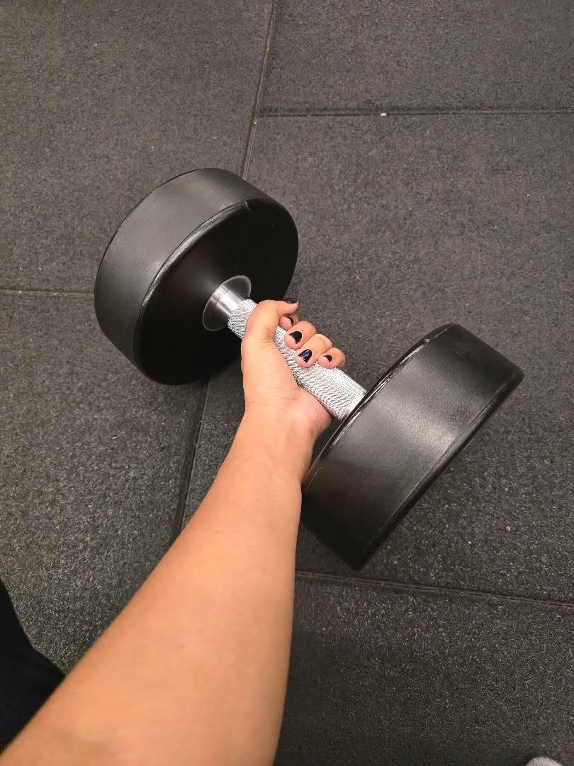 Holding a dumbbell at the gym